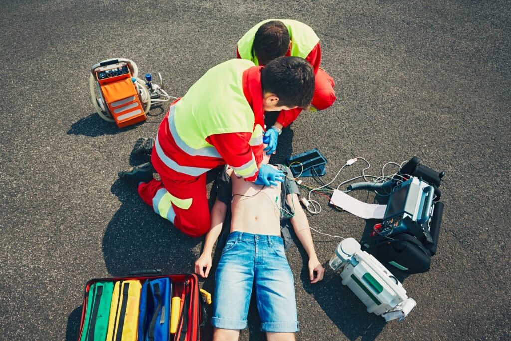 two people giving CPR to a person